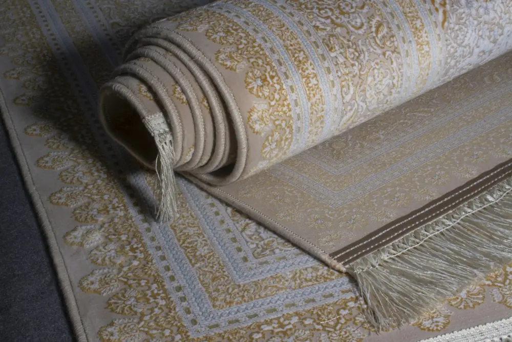 Rolled cream rug with a fringed edge