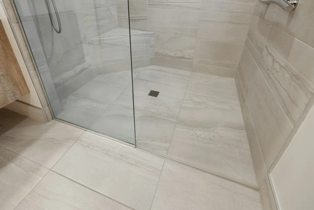 Tiled shower with a glass screen