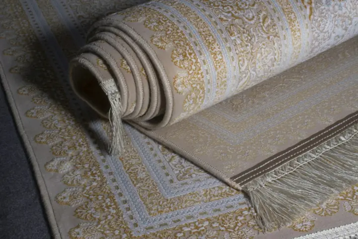 Rolled cream rug with a fringed edge